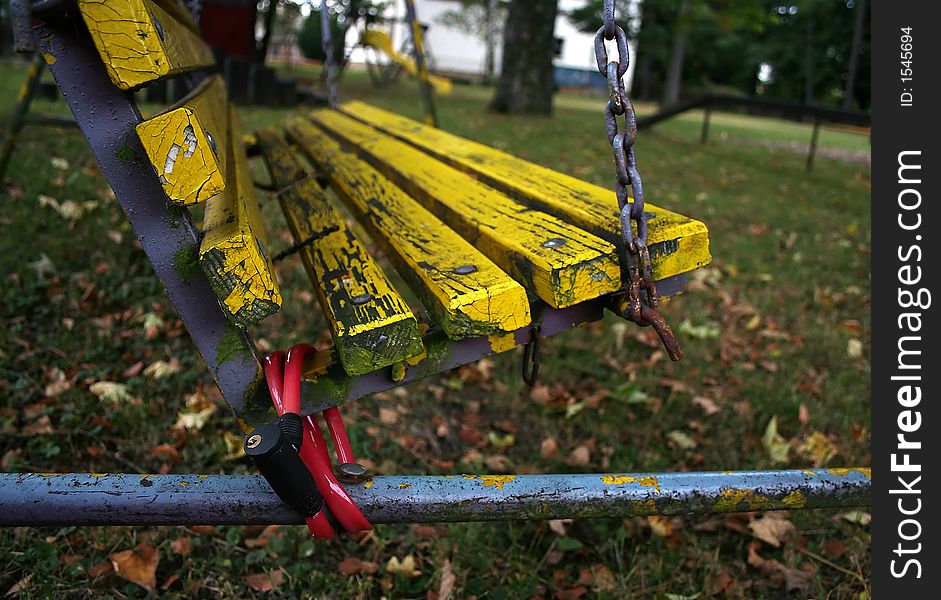 Yellow school swing chained down. Yellow school swing chained down.