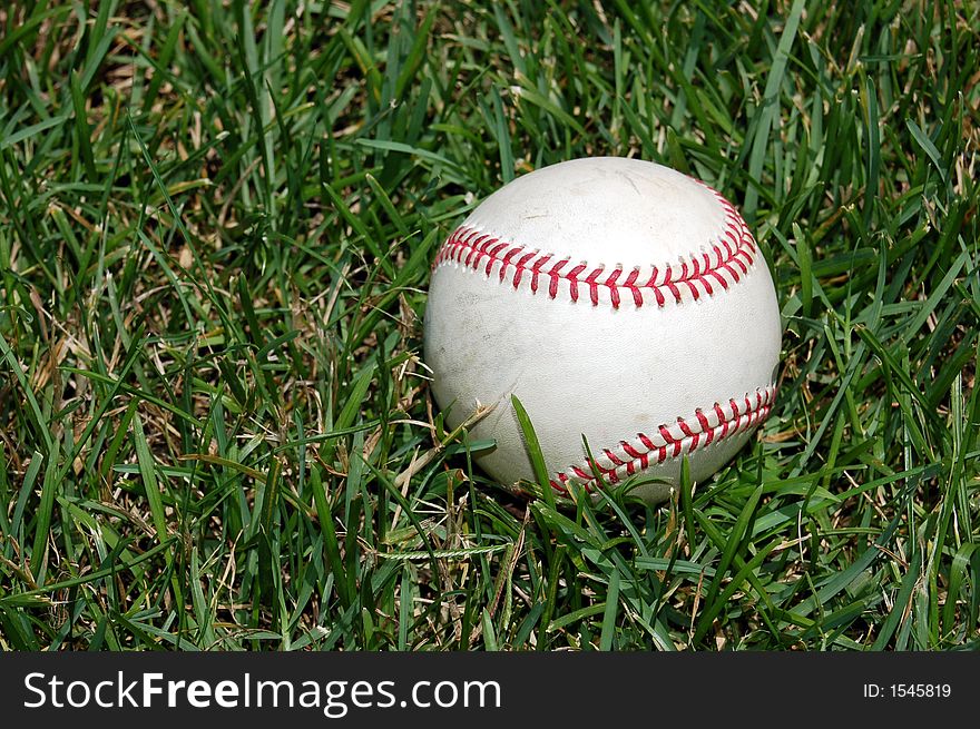Closeup of a baseball on grass. Closeup of a baseball on grass.