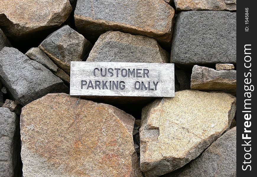 A Weathered Customer Parking Only Sign