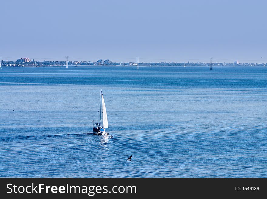 Sailboat on calm blue waters. Sailboat on calm blue waters