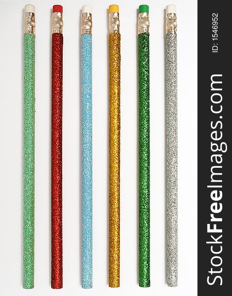 Set of celebratory color pencils with a multi-coloured brilliant covering. Set of celebratory color pencils with a multi-coloured brilliant covering