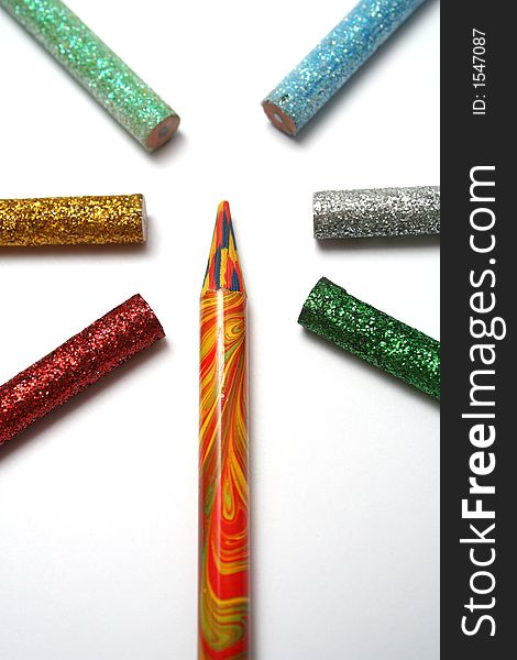 The multi-colour pencil is surrounded by brilliant color pencils