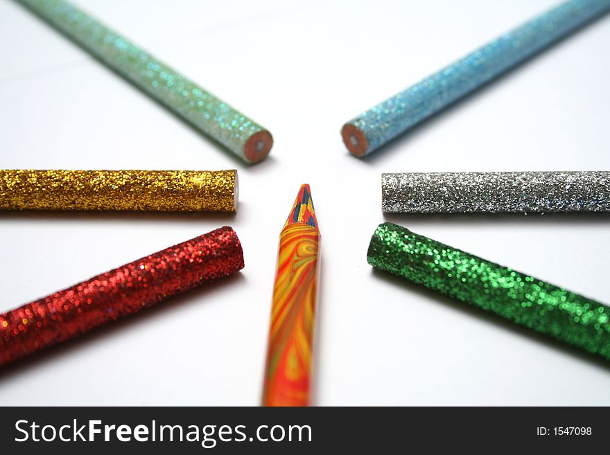 The multi-colour pencil is surrounded by brilliant color pencils from above macro. The multi-colour pencil is surrounded by brilliant color pencils from above macro