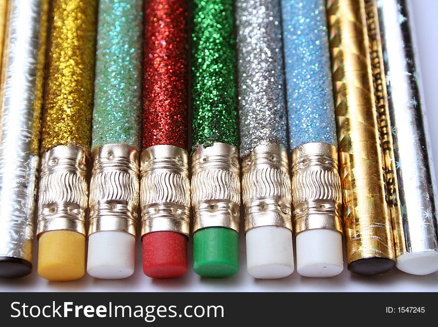Set Of Celebratory Sparkling Pencils Laying In Parallel