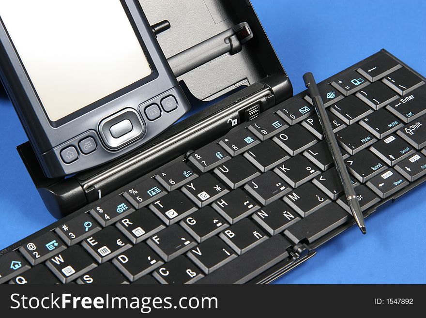 PDA and keyboard on blue background