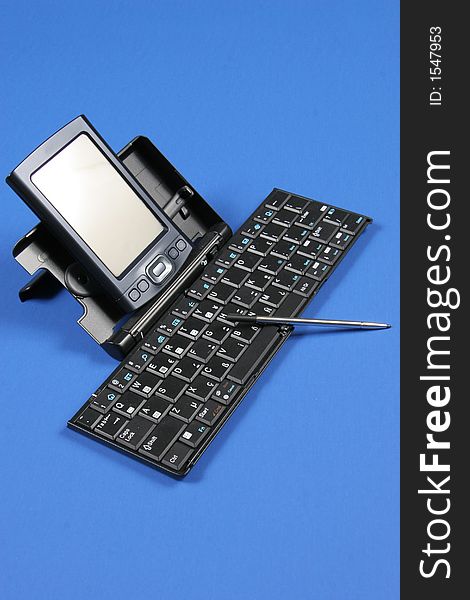 PDA and keyboard on blue background