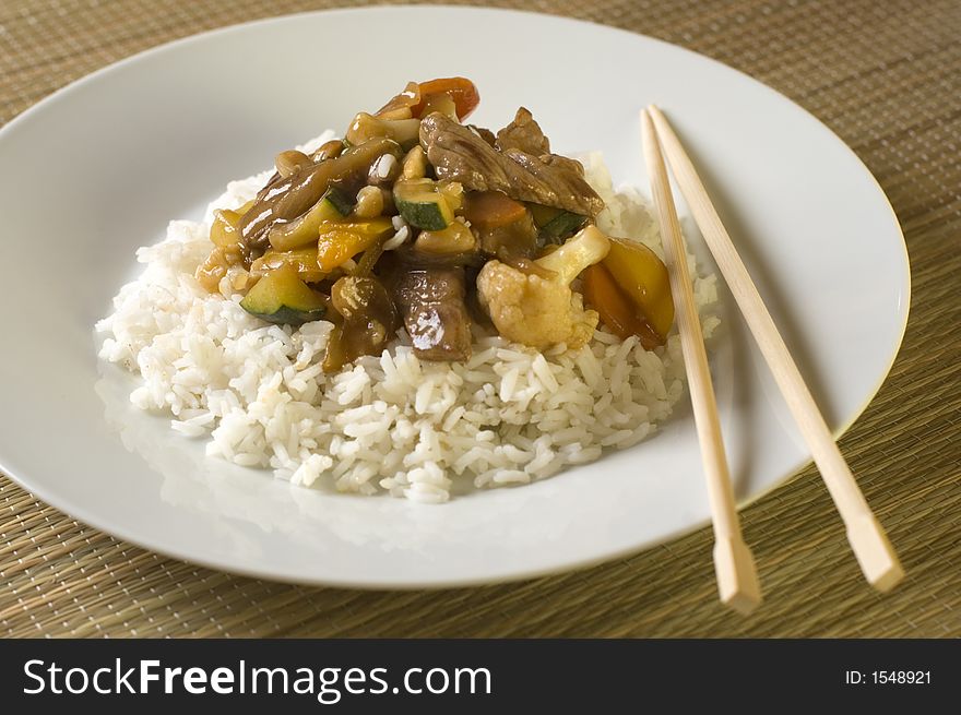 Beef china food gravy with rice on white plate