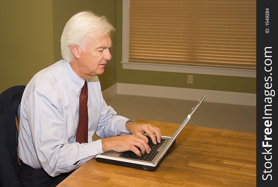 Senior Businessman on Laptop