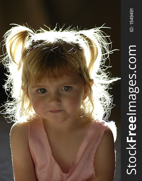 Beautiful back-lit little girl with blond hair. Beautiful back-lit little girl with blond hair