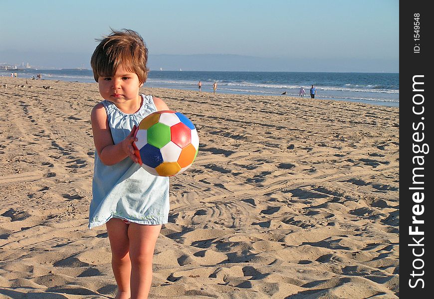 Girl Playing At The Beach