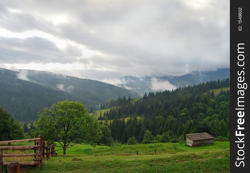 Emerald green mountainous meadow and overcast threatening sky (Jasynja village, Carpathian Mt's, Ukraine). Emerald green mountainous meadow and overcast threatening sky (Jasynja village, Carpathian Mt's, Ukraine)