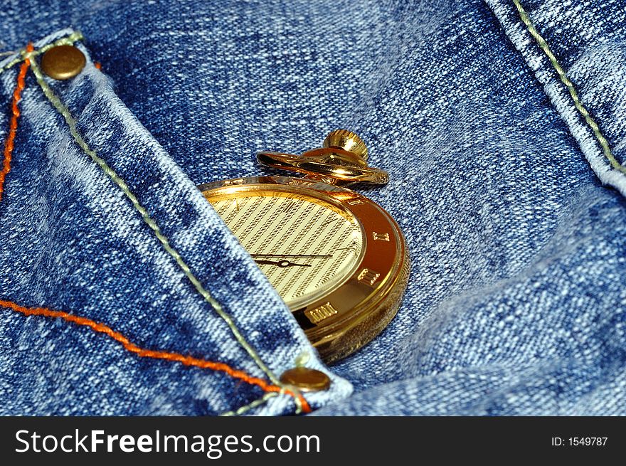 Golden pocket watch in back pocket of jean. Golden pocket watch in back pocket of jean