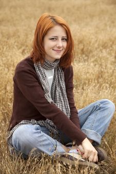 Beautiful Red-haired Girl At Yellow Autumn Grass. Royalty Free Stock Photos Beautiful Red-haired Girl At Yellow Autumn Grass. Royalty Free Stock Photos