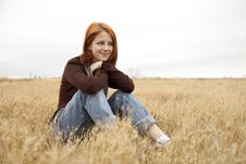 Beautiful Red-haired Girl At Yellow Autumn Grass. Stock Photo Beautiful Red-haired Girl At Yellow Autumn Grass. Stock Photo
