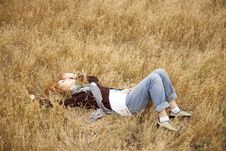 Young Beautiful Girl Lying At Yellow Autumn Field. Stock Images Young Beautiful Girl Lying At Yellow Autumn Field. Stock Images