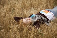 Young Beautiful Girl Lying At Yellow Autumn Field. Stock Photos Young Beautiful Girl Lying At Yellow Autumn Field. Stock Photos