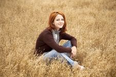 Beautiful Red-haired Girl At Yellow Autumn Grass. Stock Photos Beautiful Red-haired Girl At Yellow Autumn Grass. Stock Photos