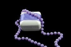 White Gift Box With Purple Satin Bow Stock Photo