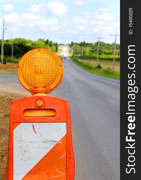 Traffic cone flasher on empty road