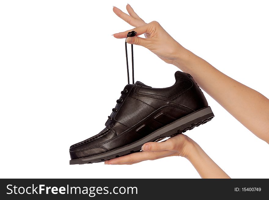 New model of black urban footwear in saleswoman's hands. New model of black urban footwear in saleswoman's hands