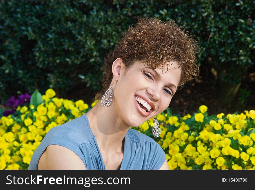 Multi-Racial Woman with nice smile with flowered background. Multi-Racial Woman with nice smile with flowered background