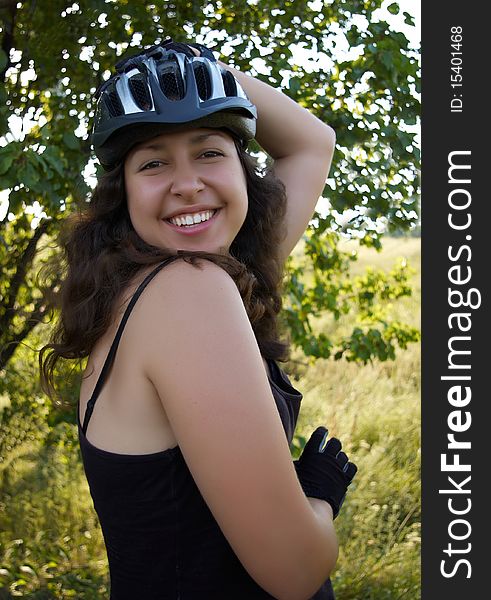 Smiling girl in bicycle helmet outdoor