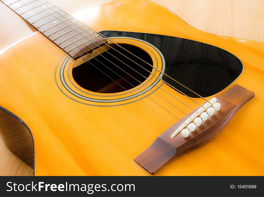 A closeup of an abstract classical acoustic guitar with strings