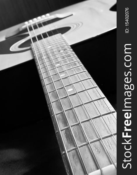 A closeup of an abstract classical acoustic guitar with strings