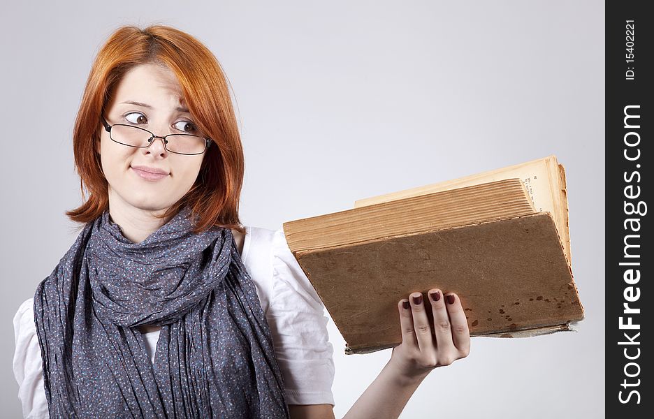 Young doubting fashion girl in glasses with old book. Young doubting fashion girl in glasses with old book