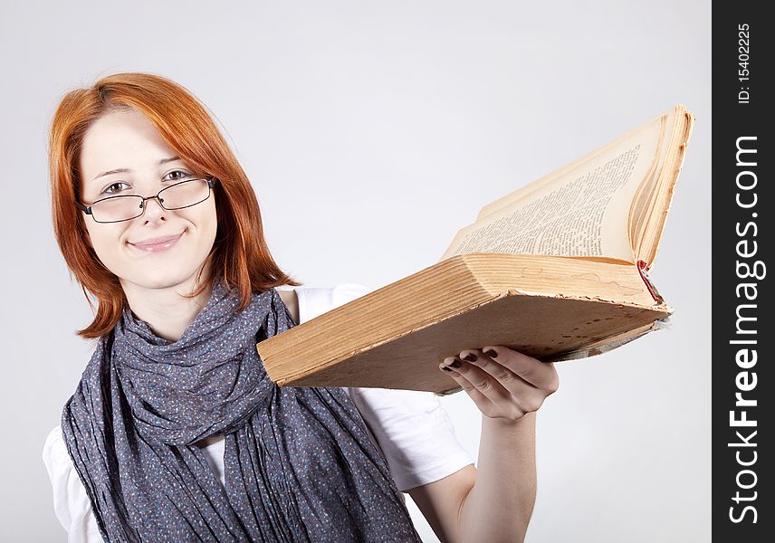 Young smiling fashion girl in glasses with age book. Young smiling fashion girl in glasses with age book.