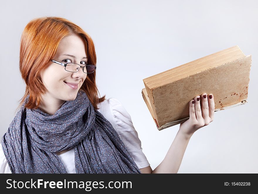 Young smiling fashion girl in glasses with age book. Young smiling fashion girl in glasses with age book.