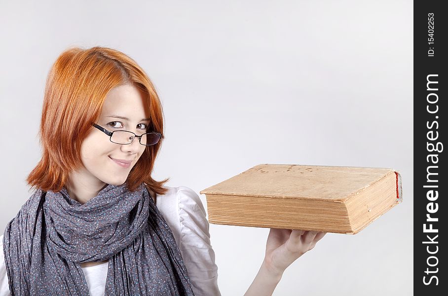 Young girl in glasses with age book.