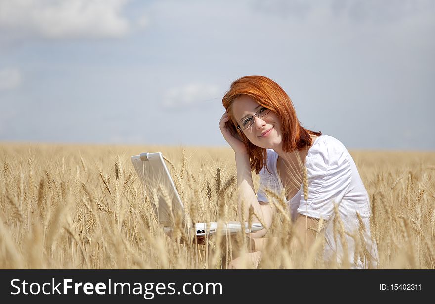 Businesswomen in white with notebook at wheat fiel