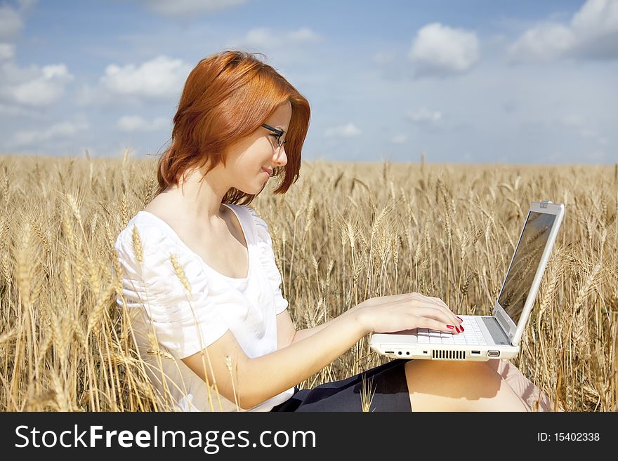 Businesswomen in white with notebook at wheat fiel