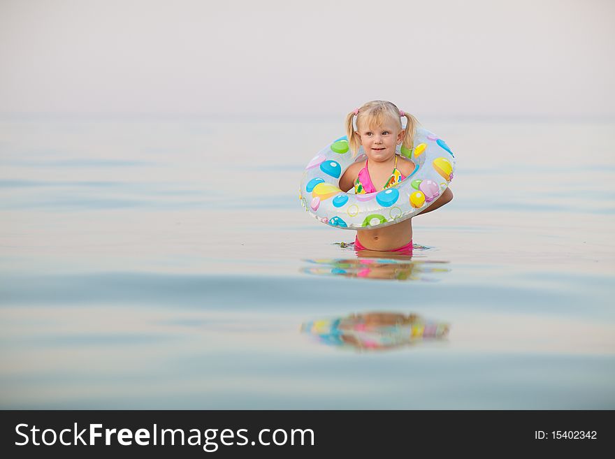 Small girl in water with inflatable buoy. Small girl in water with inflatable buoy