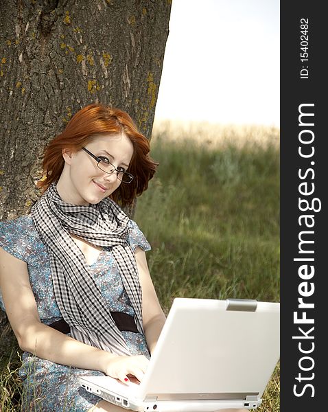 Young Smiling Girl In Glasses And Notebook