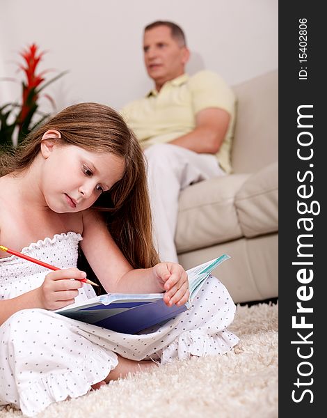 Cute girl studying with her father