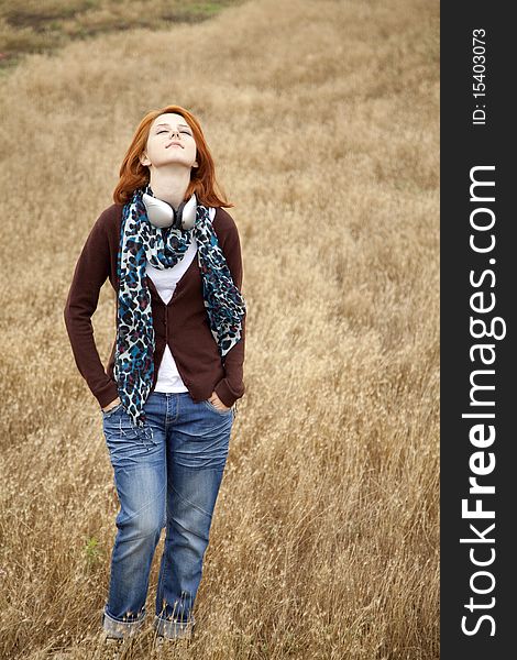 Young Girl With Headphones At Field.