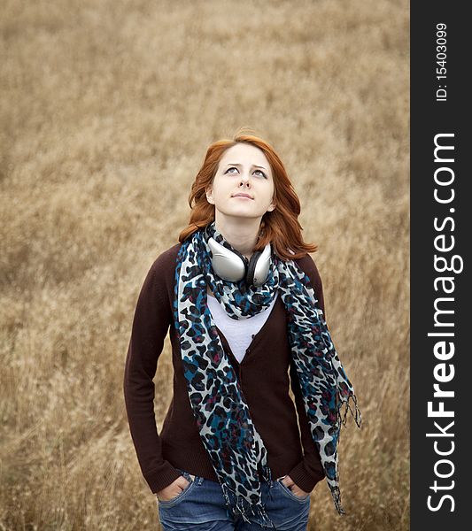 Young Girl With Headphones At Field.