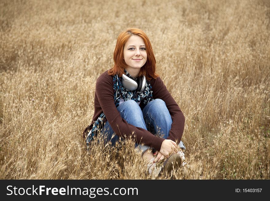 Young Girl With Headphones At Field.