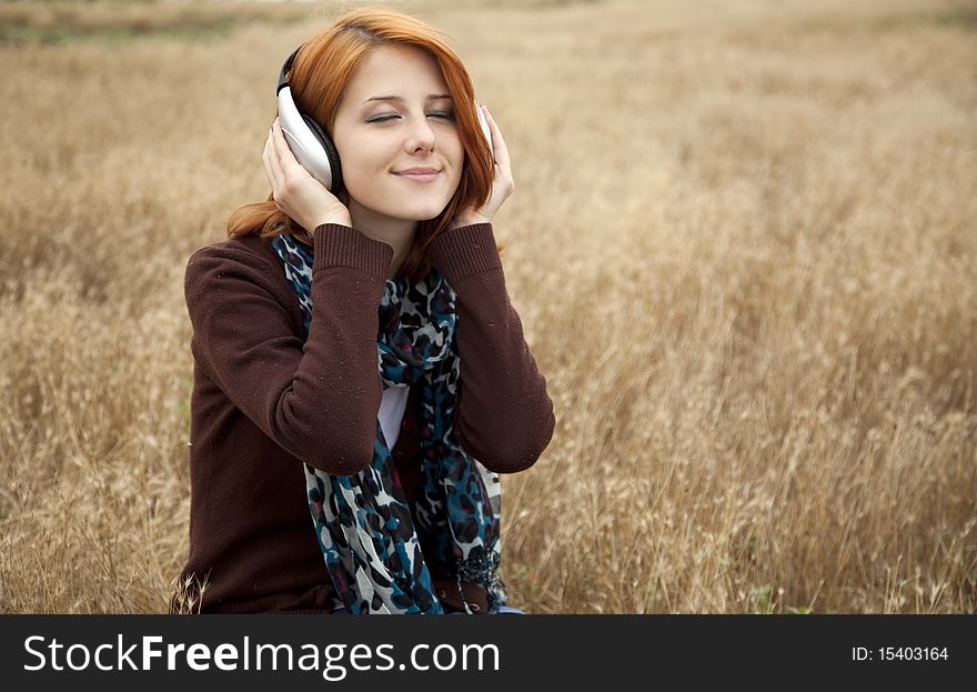 Young Girl With Headphones At Field.