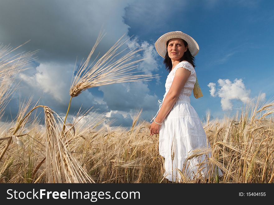 Lady in white dress and hat in the wheat field. Lady in white dress and hat in the wheat field