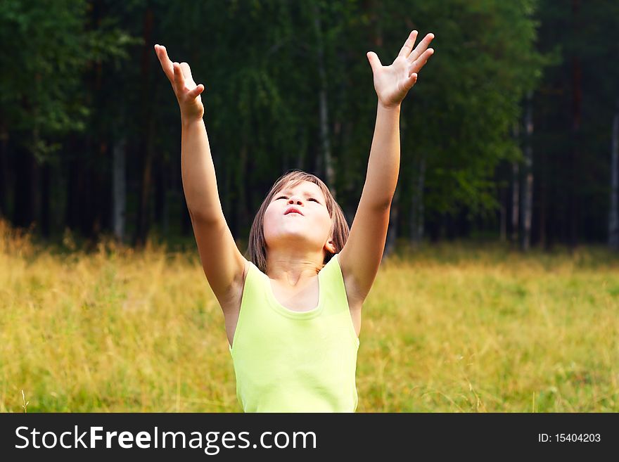 The child on open air, extends hands upwards. The child on open air, extends hands upwards