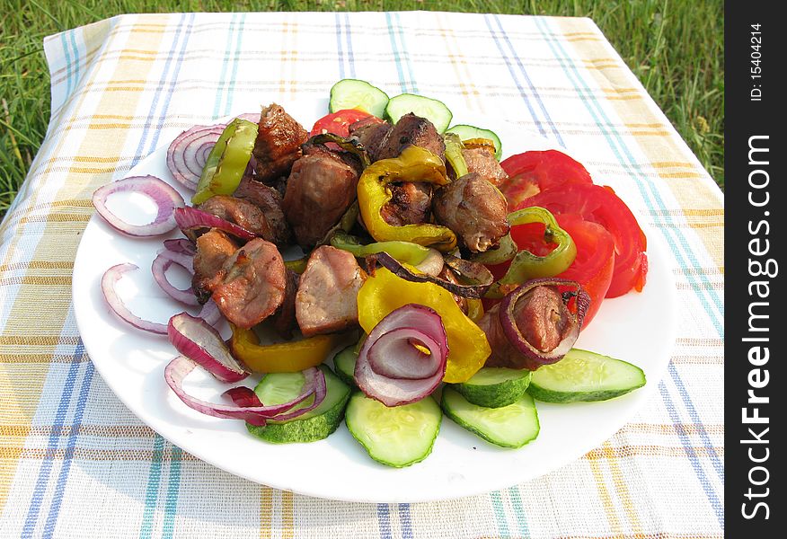 Cooked meat with carrot onion and lemon slices barbecue food. Cooked meat with carrot onion and lemon slices barbecue food