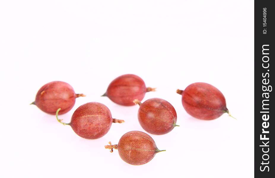 Red gooseberries on white background