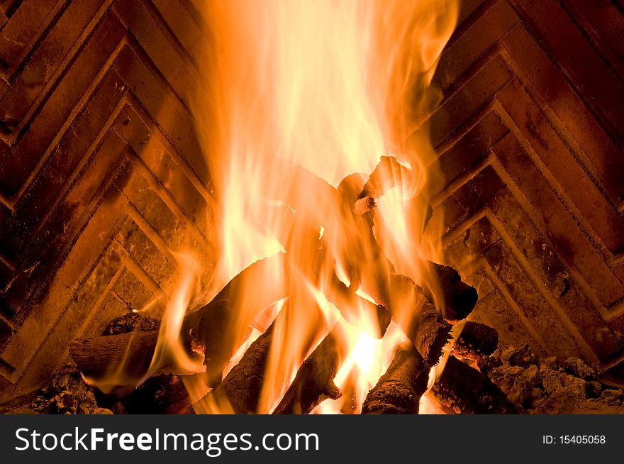 Flames dry wood burning in a fireplace