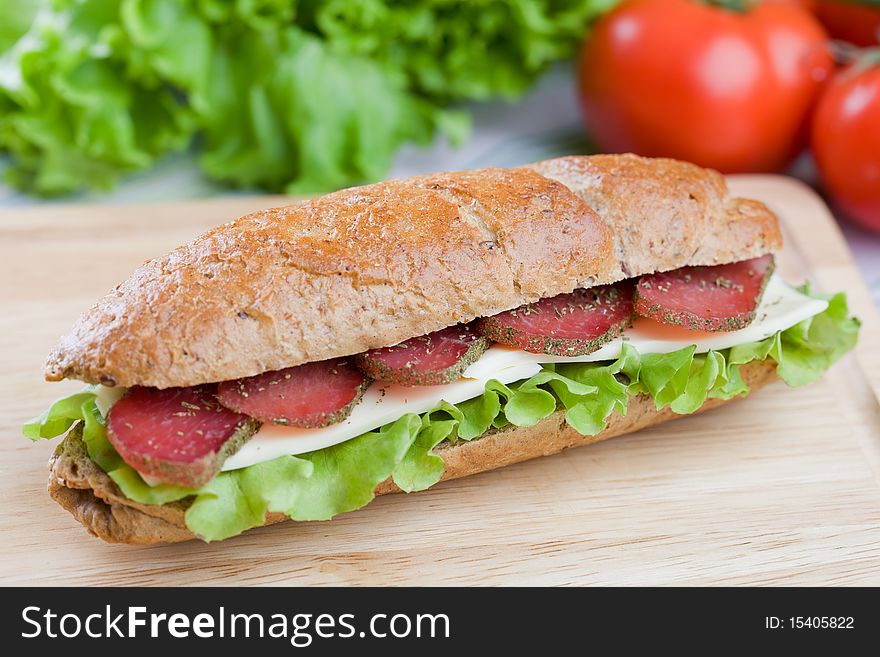 Fresh sandwich with dry meat and cheese on dietetic bread