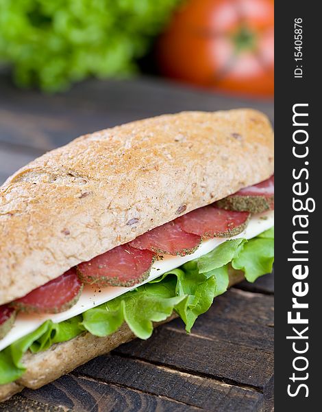 Big freshly made sandwich with lettuce , cheese and meat