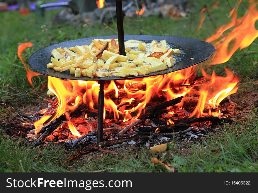 Fried potatoes on barbecue