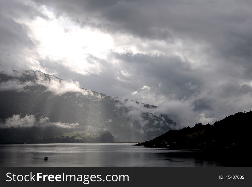 Sun's rays pierce the cloud over Nordfjord. Sun's rays pierce the cloud over Nordfjord